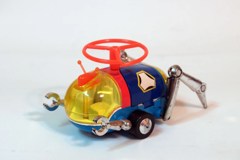a little toy truck with yellow and red wheels