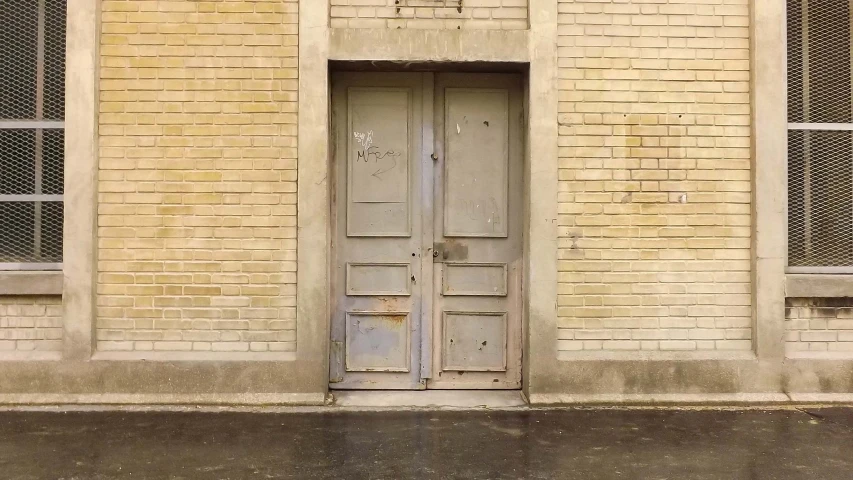 a person walks past an old building with an open door