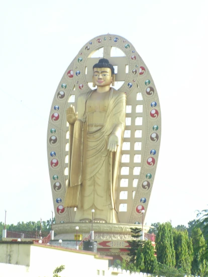 a giant statue of buddha in front of a building