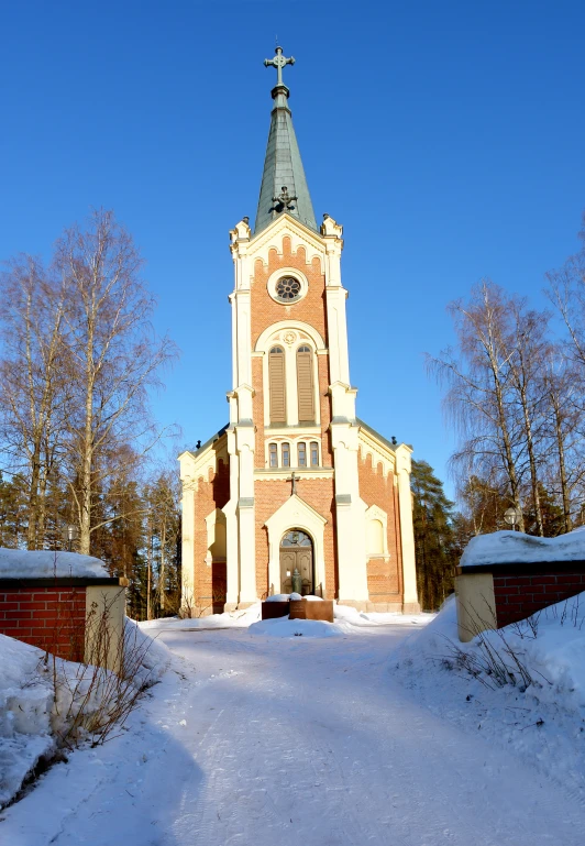 a snowy street leading up to a church