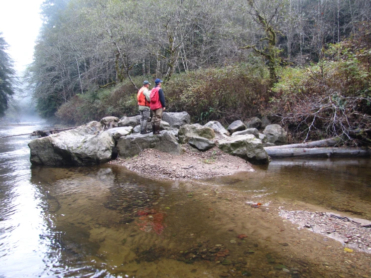 a person standing on a rock out in the water