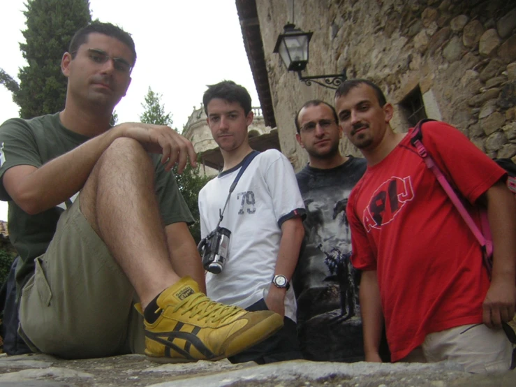 three men are posing in the sunshine for a picture