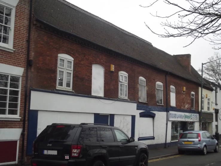 a couple of cars are parked on the side of a street