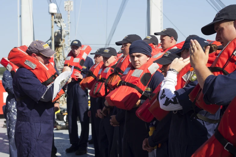 a group of people in life jackets standing next to each other