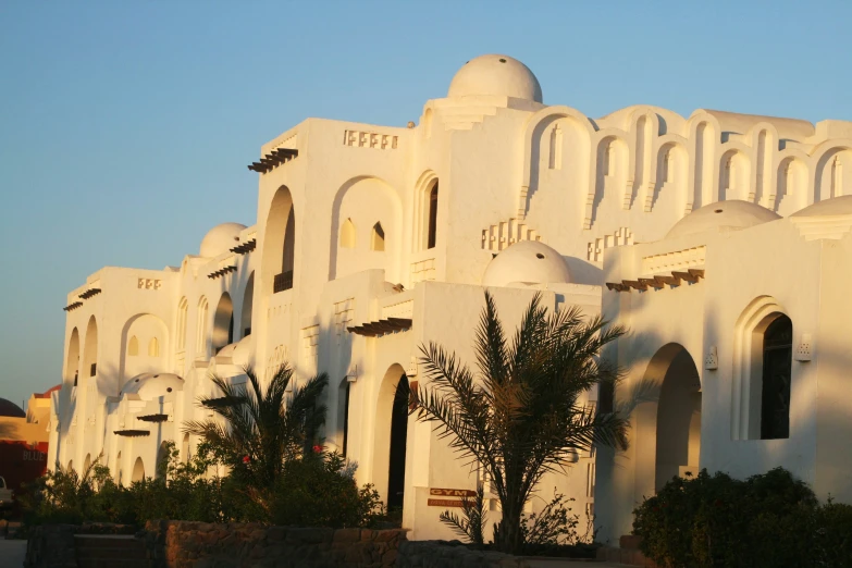 white building made up of stucco with arches and minalis