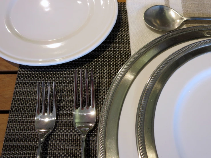 a fork and a silverware are laid out next to a plate