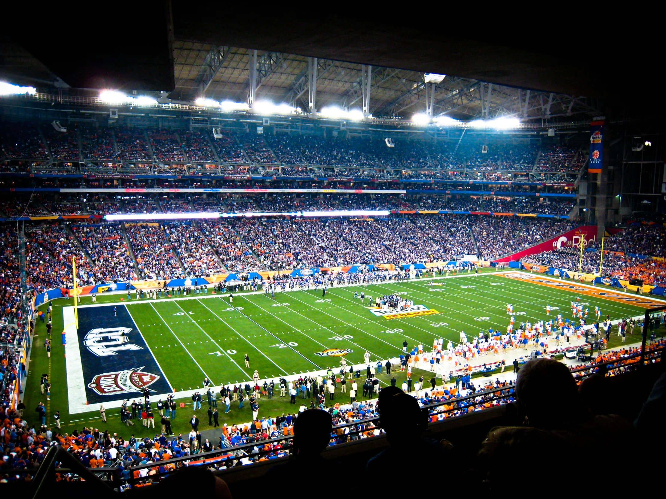 a football stadium full of spectators with people sitting in seats