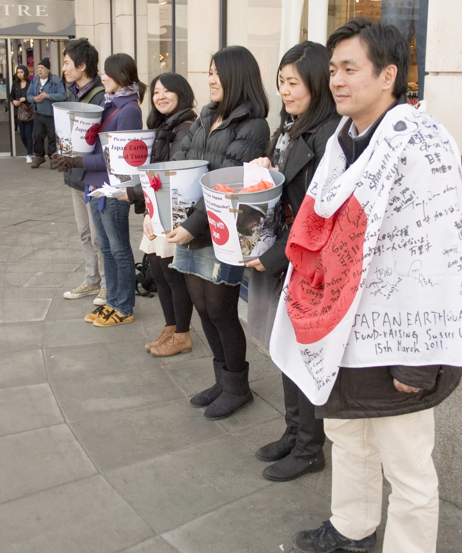 a group of people on a street holding a sign