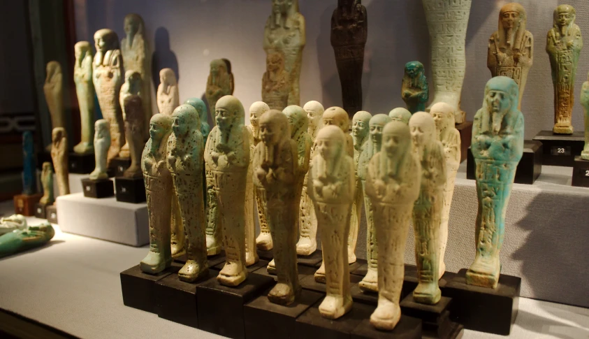 an assortment of statues and a vase on display