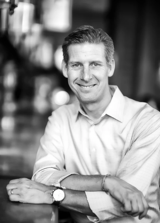 a black and white portrait of a man in a white shirt