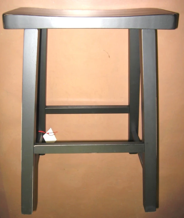 a metal stool with a wooden seat is next to a shelf with a small toy mouse