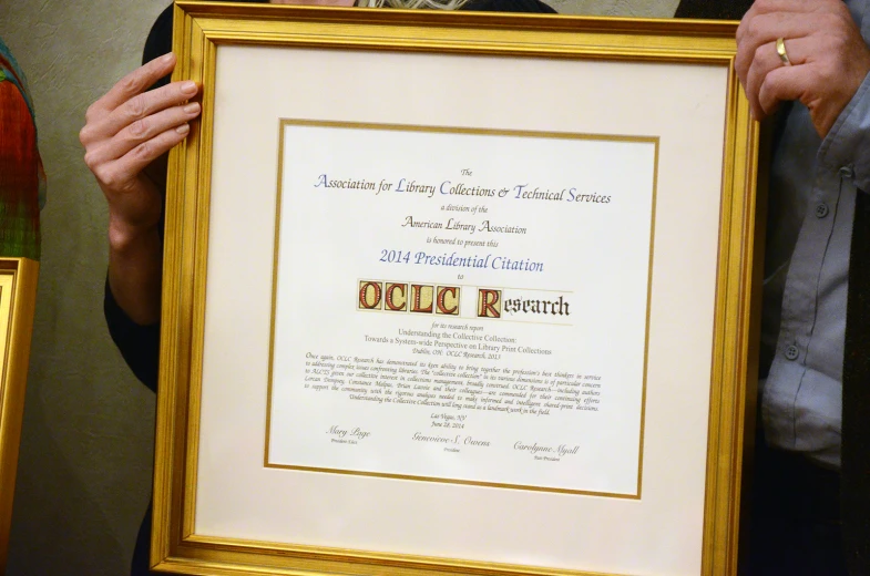 two people with a framed diploma in their hands