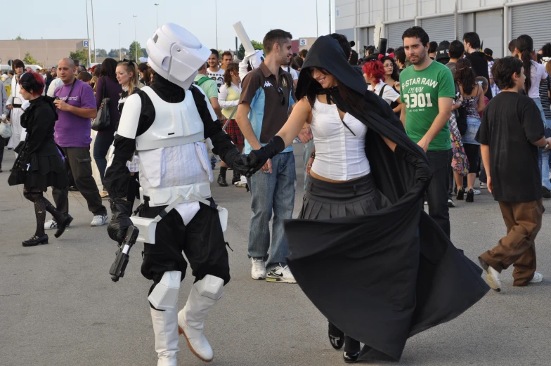 a person dressed as storm trooper is walking through the street