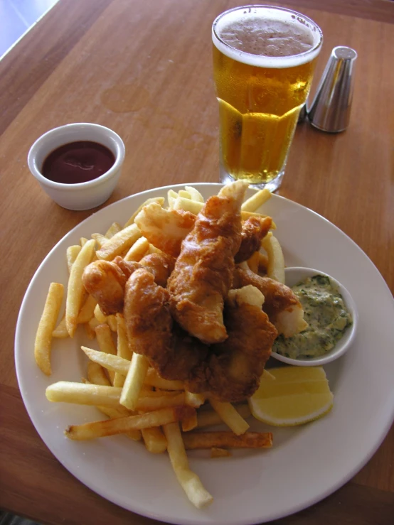 a plate that has some french fries and a chicken in it