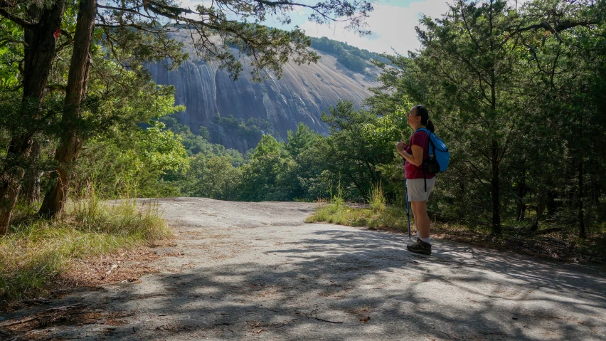 a man is walking along a dirt path