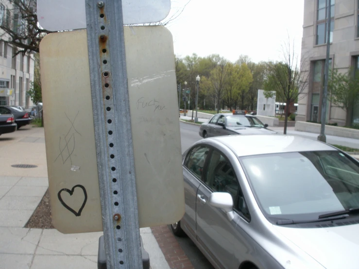 a parking meter with a sign attached to it