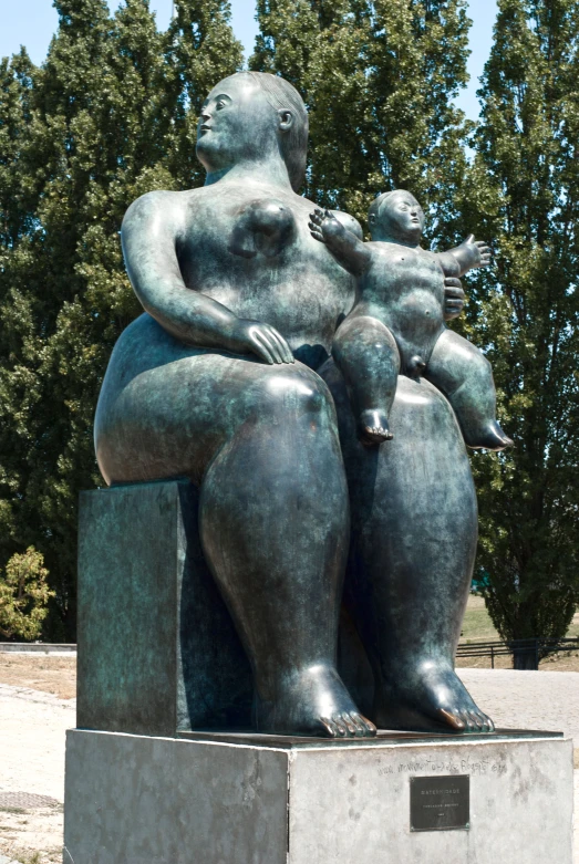 a statue of three people sitting on top of each other