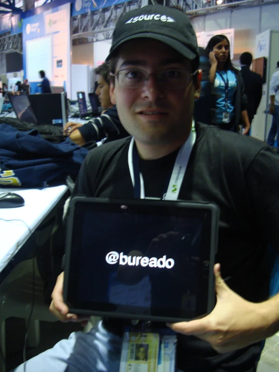 a man at an event holding a display of electronic equipment