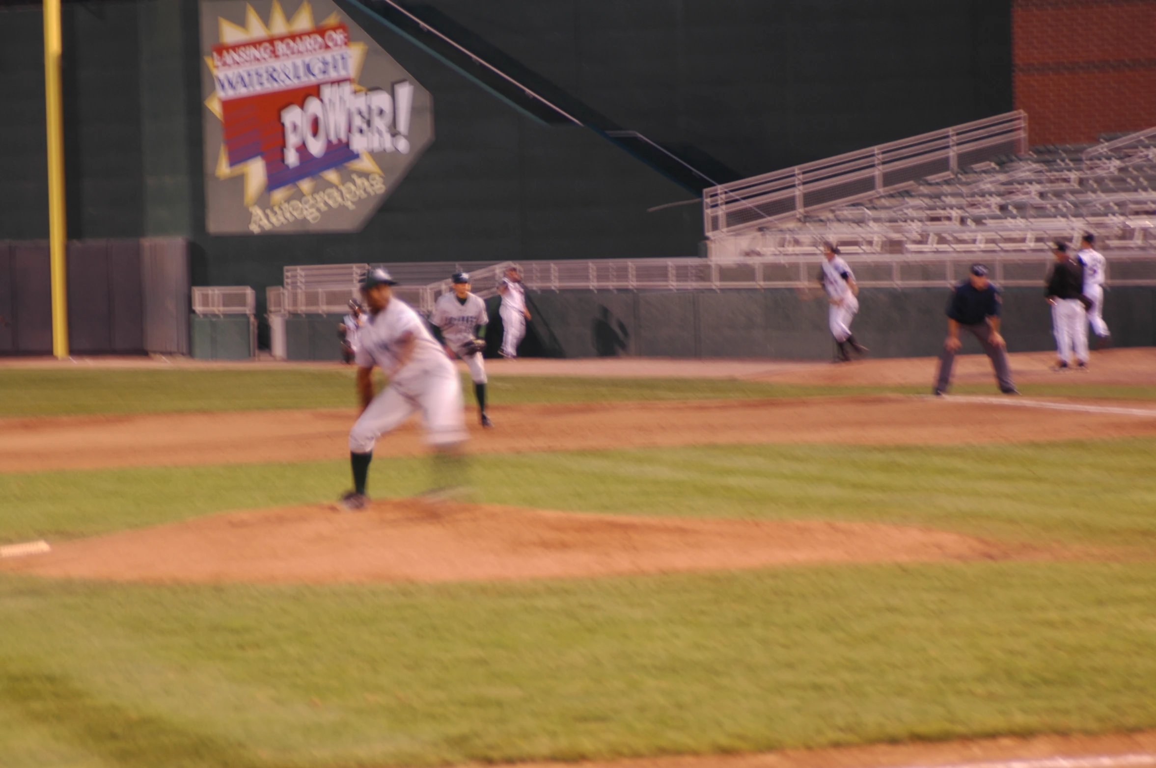 men in white uniforms playing a baseball game