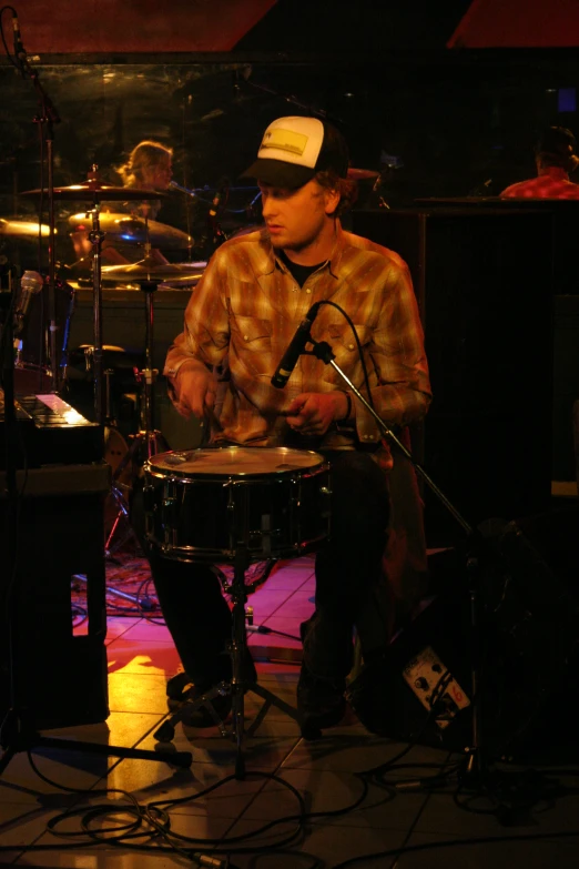 a man sitting on top of a drum kit