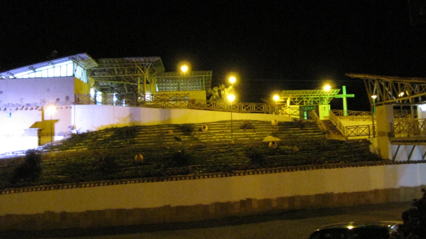 a couple of large green benches in front of a building