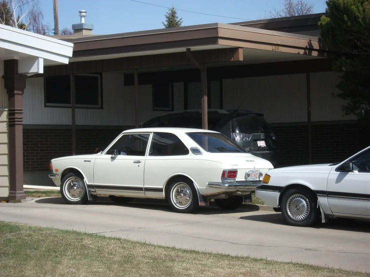 two cars parked next to each other in front of a house