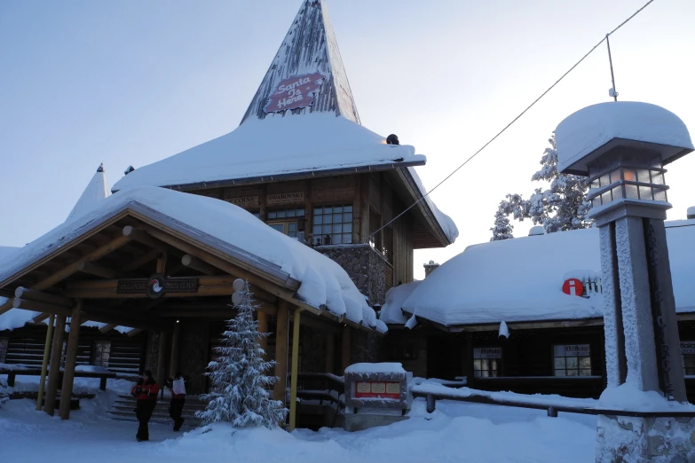 a small wooden building on a snowy day