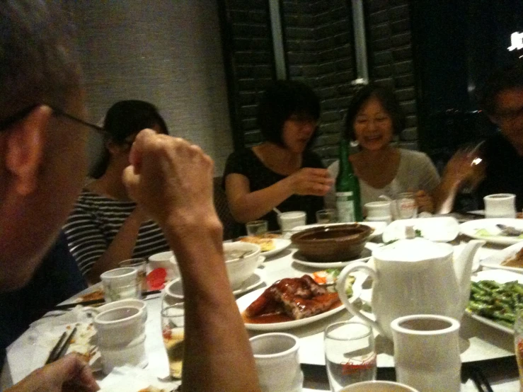 a group of people sit around a table sharing food