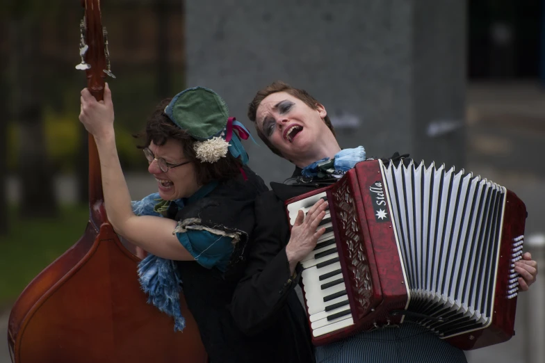 two people dressed in costume and holding musical instrument