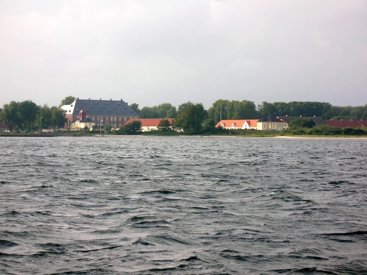 a house is visible from across the water in the distance