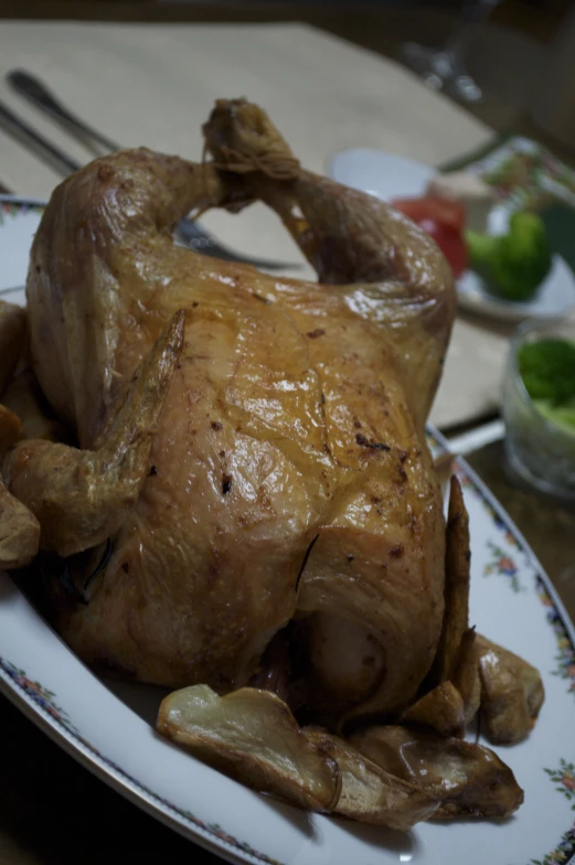 a cooked chicken sitting on top of a plate