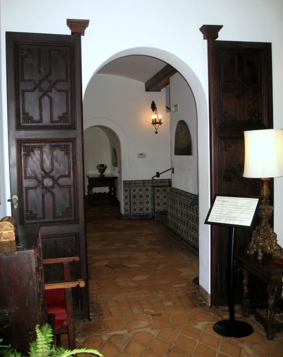 a living area with wooden doors in an arch