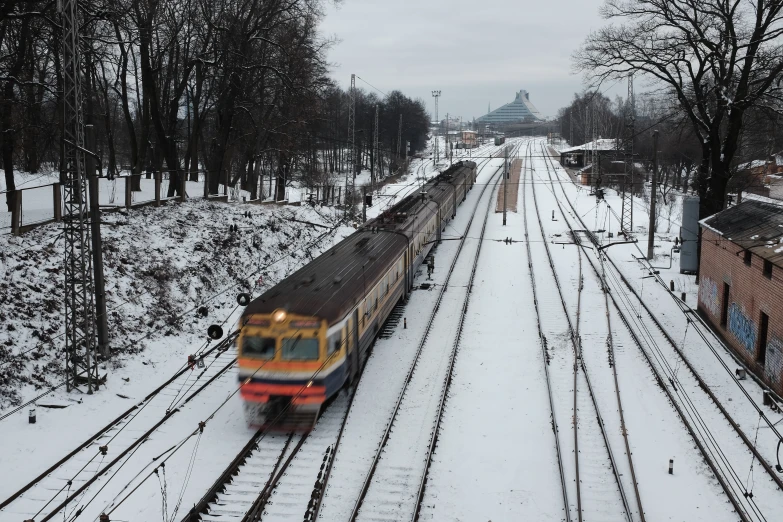 a train that is on the tracks in the snow