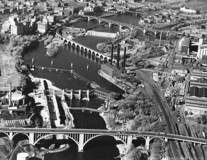 black and white pograph of a city area, with river running through it