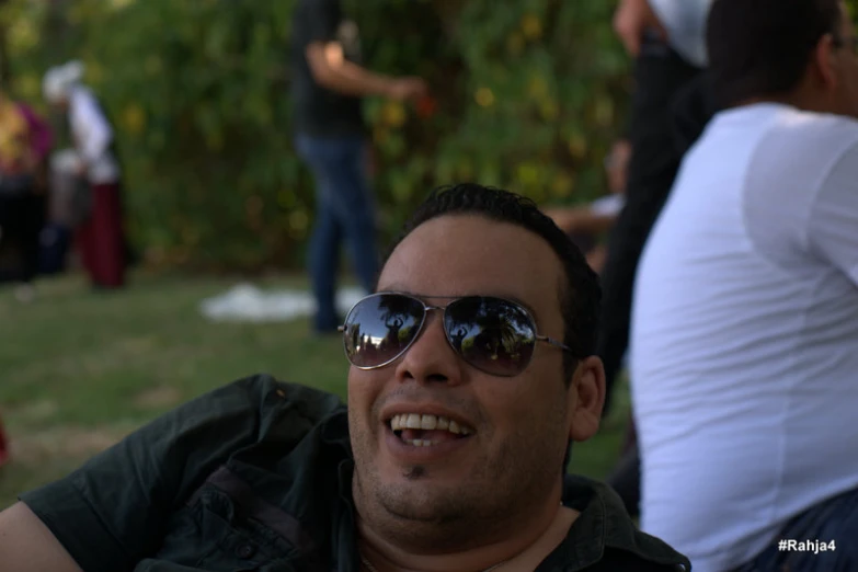 a man is smiling for the camera with sunglasses on