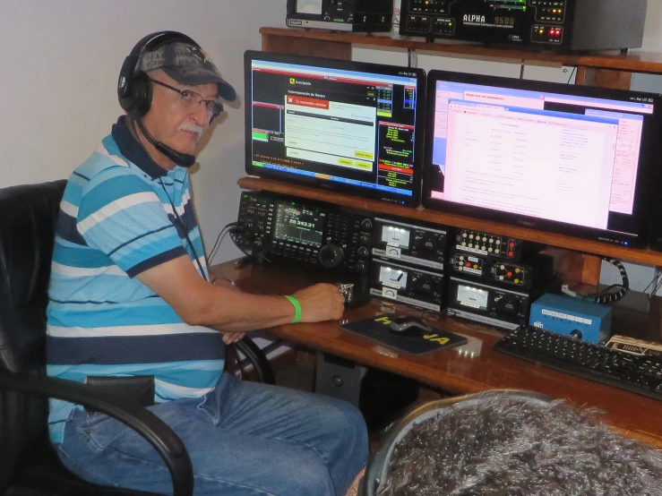 a man in the control room working on several monitors