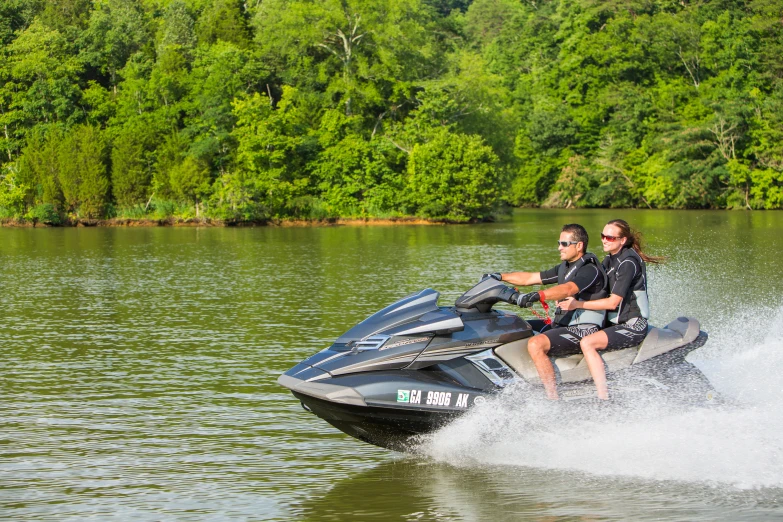 two people driving a jet ski on a lake