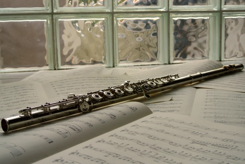 a flute sits on top of music mcripts