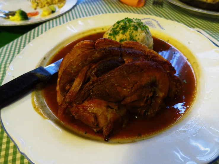 a plate with some meat covered in gravy