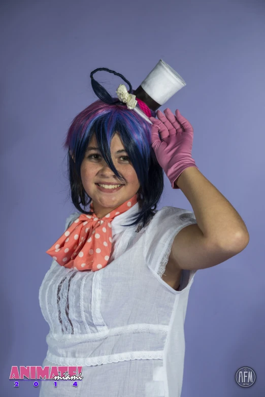 a woman with blue hair and an orange and white polka dot scarf holding a wine glass in the air