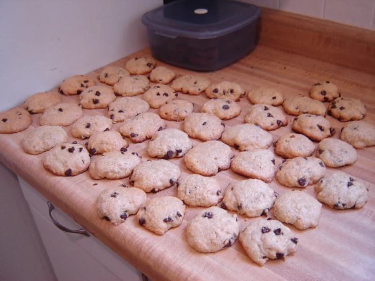 a wooden table topped with a pile of cookies