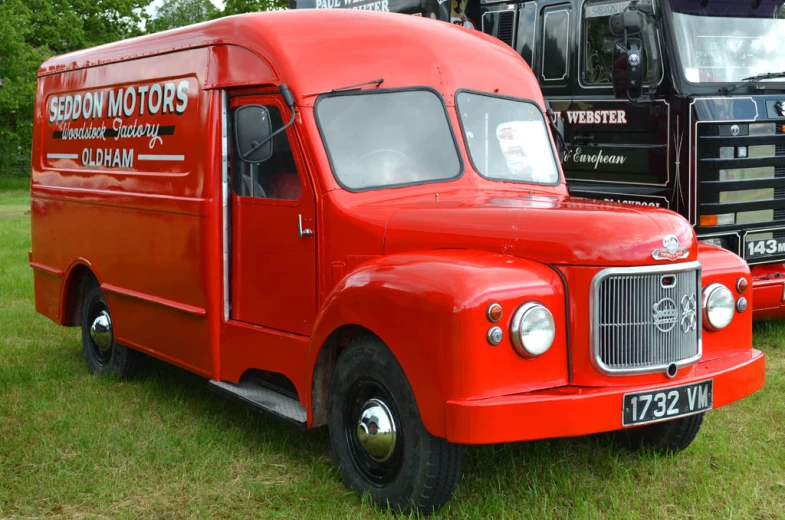 there is an old red and black truck that looks similar to a small van