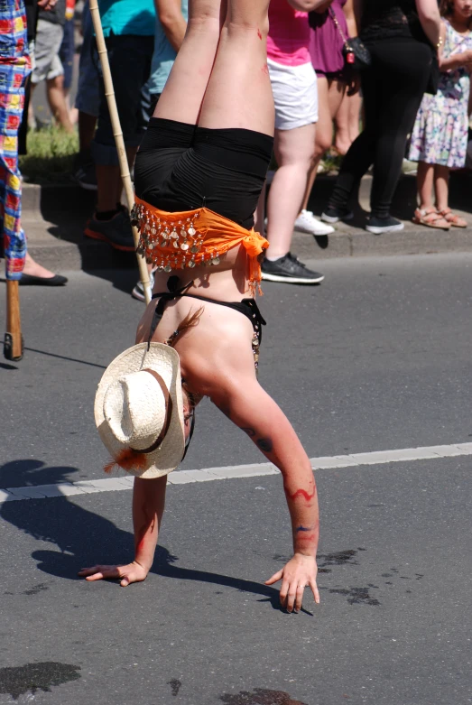 a woman upside down with her  and hands in the air