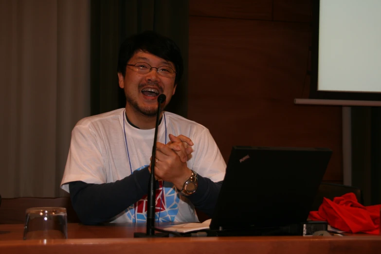 a man that is sitting in front of a laptop