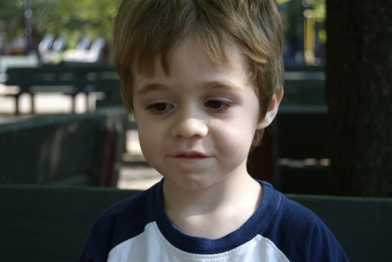 a close up of a child on a bench