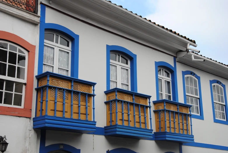 many multi colored building on the streets with blue and yellow balconies