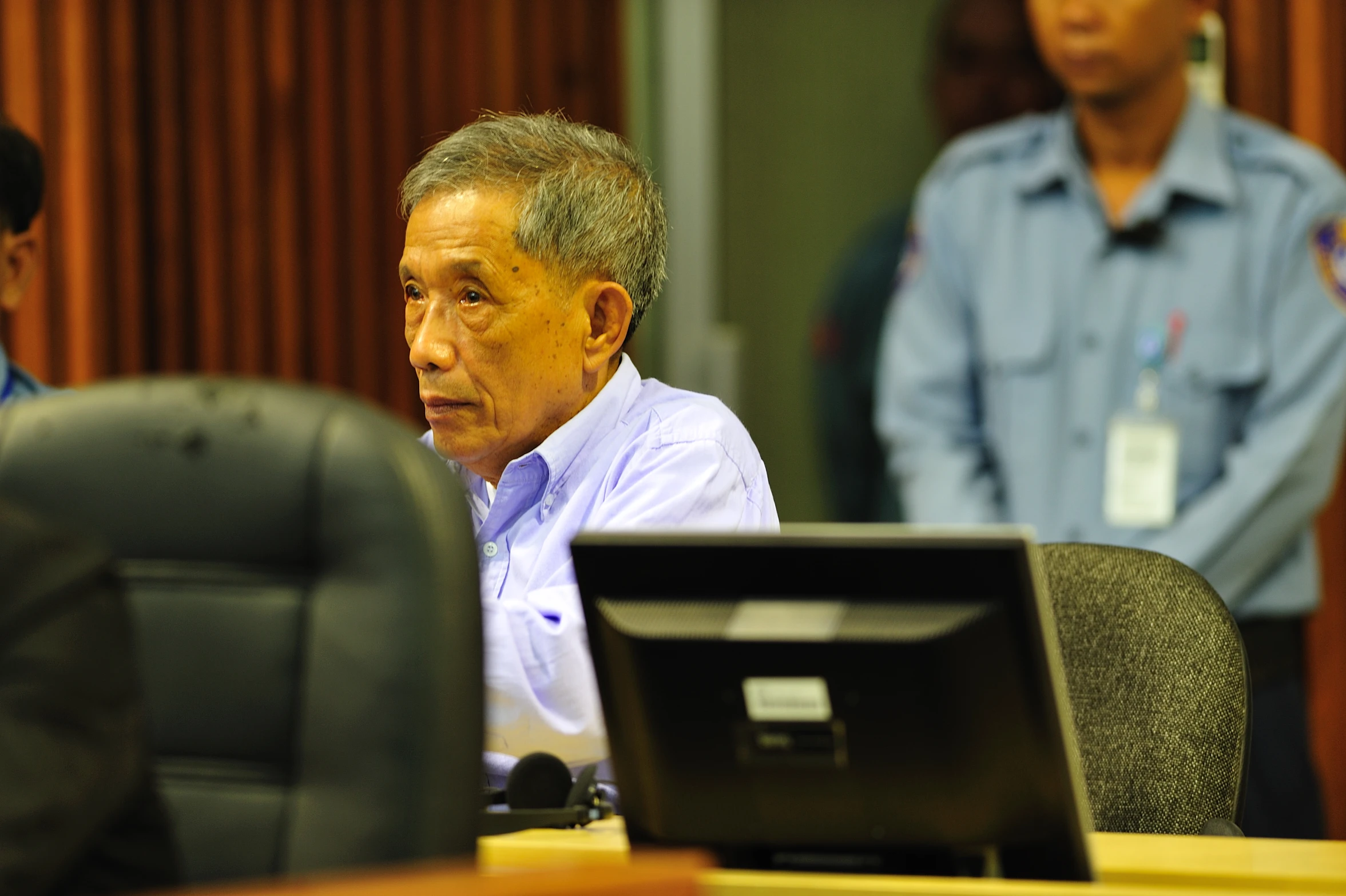 a man sitting in front of a monitor