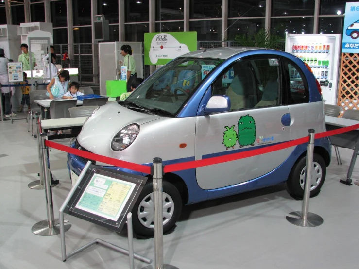 a car parked on display next to a red and white line