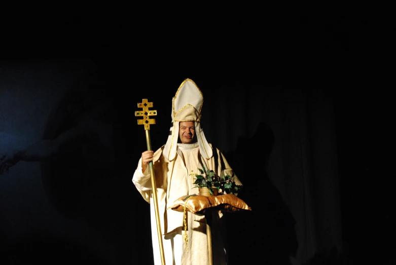 a man in a white robe holding bread