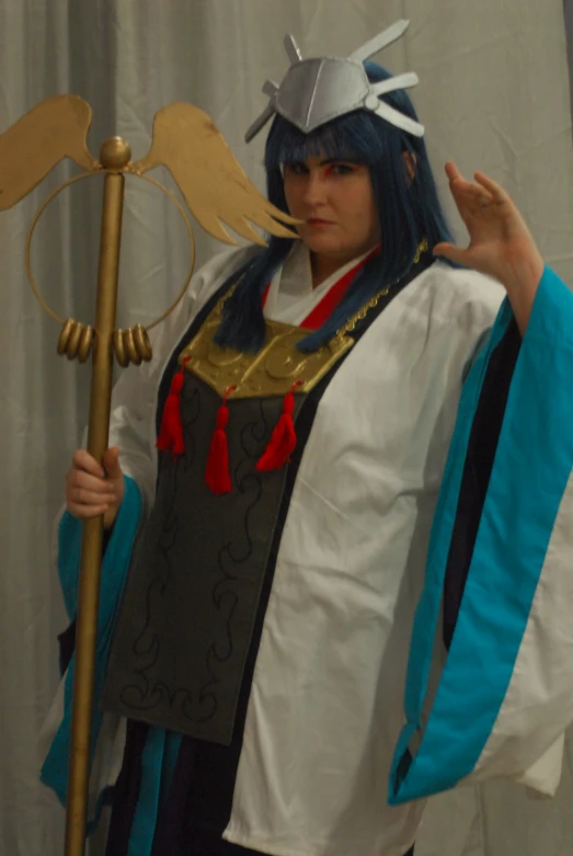 a woman dressed in cosplay clothing with long blue hair